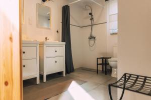 寇帕利諾的住宿－Toniegóry - domki letniskowe w Kopalinie，白色的浴室设有水槽和淋浴。