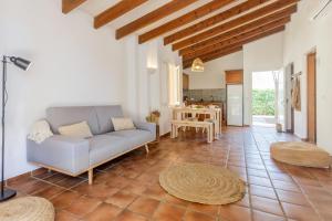 a living room with a couch and a table at S'avarqueta in Son Xoriguer