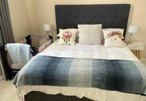 una camera da letto con un grande letto con fiori di Seapoint Gem a Città del Capo