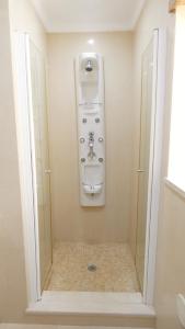 a bathroom with a shower with a sink and a toilet at Apartamento Íris in Lagos