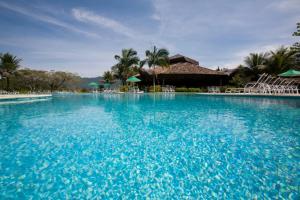 a large swimming pool with blue water in a resort at Hotel do Bosque ECO Resort in Angra dos Reis