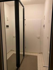 a bathroom with two white doors and a mirror at Nice and comfortable studio in Pankow in Berlin