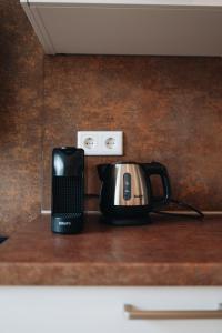 a coffee maker and a tea kettle on a counter at Hotel - B&B Renesse in Renesse