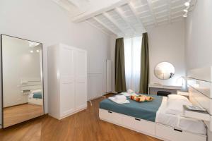 a bedroom with a bed and a large mirror at La Mole Central & Comfy Apartment in Turin