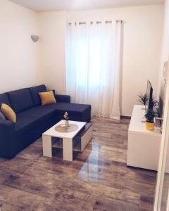 a living room with a blue couch and a coffee table at BRAND NEW lovely apartment Bella in Dubrovnik