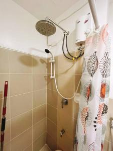 a shower in a bathroom with a shower curtain at SM Southmall condo 2br unit with mall view in Manila