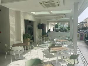 a restaurant with tables and chairs and a balcony at Hotel Astra in Riccione