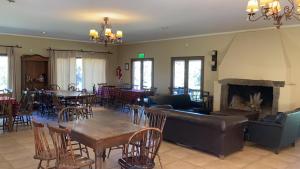 a living room with a couch and tables and chairs at Quinta El Monte in Tandil