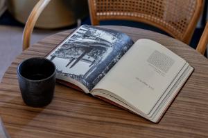 an open book on a table with a cup of coffee at Regras 45 Building B by LovelyStay in Porto