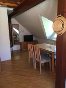 a dining room with a table and chairs at Apartments Otašević in Kranjska Gora