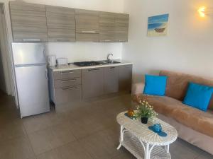 a living room with a couch and a table at Apt14 Porto Antigo 1 with Pool and Beach views in Santa Maria