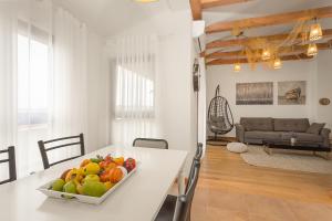 a bowl of fruit on a white table in a living room at Apartments Cesare with Shared Pool in Ližnjan