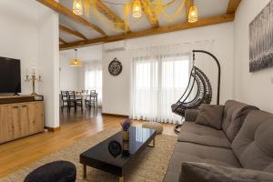 a living room with a couch and a table at Apartments Cesare with Shared Pool in Ližnjan