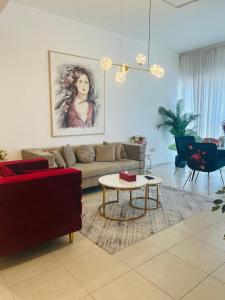 a living room with a couch and a table at 1-Bedroom Apartment Rental Unit With Pool in Dubai Land Residence Complex Dubai Al Ain Road in Dubai