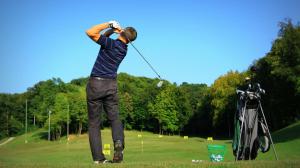 a man swinging a golf club on a golf course at Apartman Hanna Toplice Sveti Martin in Sveti Martin na Muri