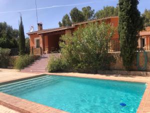 una villa con piscina di fronte a una casa di Chalet rural con piscina en plena naturaleza a Tibi