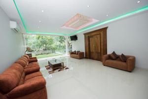 a living room with two couches and a tv at Mount Rich Rumassala By JMS Group in Unawatuna