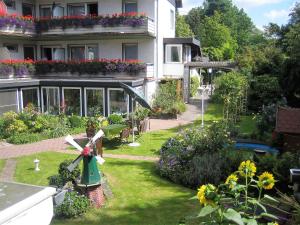 a house with a garden with a windmill in the yard at Hotel Aura am Schloss in Bad Pyrmont