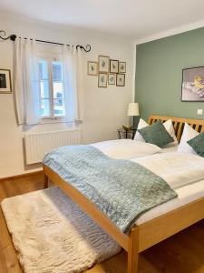 a bedroom with a large bed and a window at Burgi Kefer in Bad Ischl