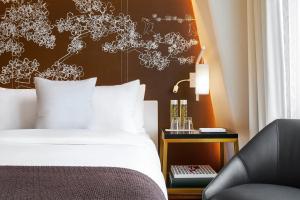 Un ou plusieurs lits dans un hébergement de l'établissement Hotel Washington