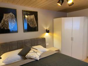 1 dormitorio con 1 cama y armario blanco en Villa Martini Boutiquehotel, en Velden am Wörthersee