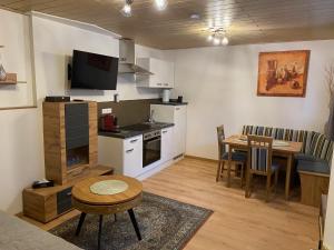 a living room with a kitchen and a table with a dining room at Villa Martini Boutiquehotel in Velden am Wörthersee