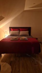 a bedroom with a bed with two towels on it at Le 4 in Montignac
