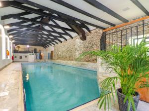 an indoor swimming pool with a brick wall at Trewince Manor Cottage in Truro