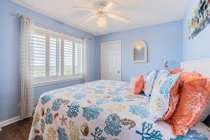 a bedroom with a bed and a ceiling fan at Tradewinds #1008 in Orange Beach