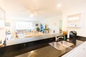 a kitchen with a sink and a living room at Lagoon Villa 25 - Heart of Wild Dunes, Quick Walk to Beach in Isle of Palms