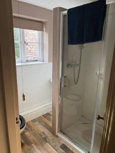 a bathroom with a shower with a glass shower stall at Historic Town Centre Cottage in Bury Saint Edmunds