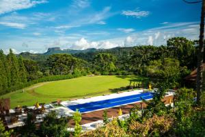 an aerial view of a resort with a large swimming pool at Surya-Pan Hotel Refúgio in Campos do Jordão