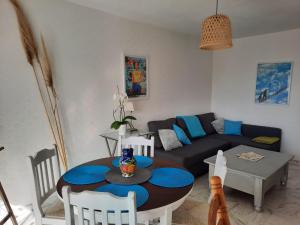 een woonkamer met een tafel en een bank bij Appart proche plage avec grand balcon in Cannes