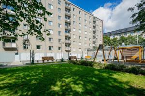 a park with a playground in front of a building at Forenom Serviced Apartments Helsinki Lapinlahdenkatu in Helsinki