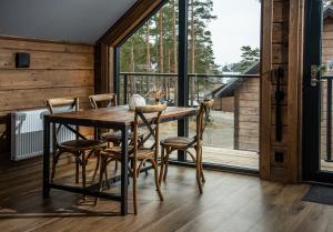 a dining room with a wooden table and chairs at Laxhall Hotell Krog Konferens in Torsö