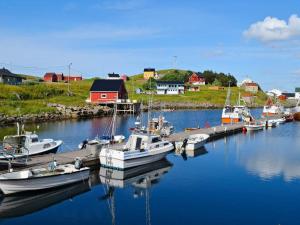 a group of boats docked at a dock in a harbor at Holiday home SORTLAND III in Sortland