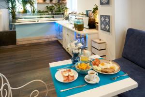 a breakfast table with two plates of food on it at Hotel 54 Barceloneta in Barcelona