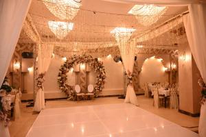 a banquet hall with a table set up for a wedding at Indiana Hotel in Cairo