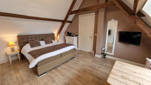 Postel nebo postele na pokoji v ubytování B&B De Droomhoeve