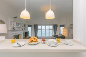 a kitchen with a table with a bowl of bread at 4 Pentowan Court in St Ives