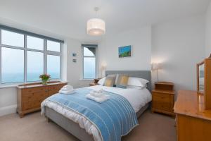 a bedroom with a bed with two towels on it at 4 Pentowan Court in St Ives