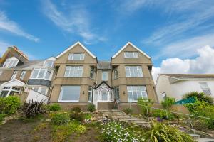 a large house with a fence in front of it at 4 Pentowan Court in St Ives