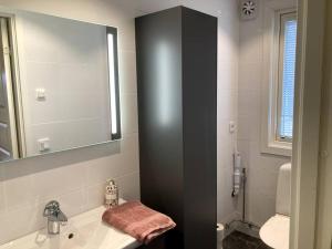 a bathroom with a sink and a mirror at Trevlig stuga/gårdshus med egen parkering in Burträsk