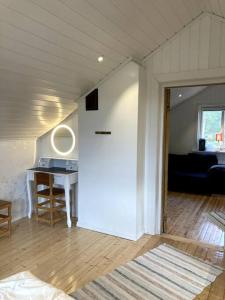 a living room with a white door and a desk at Trevlig stuga/gårdshus med egen parkering in Burträsk