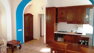 a kitchen with wooden cabinets and a wooden table with a table at Lovely Apartment in Testaccio, Rome in Rome