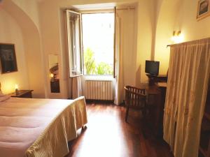 a bedroom with a bed and a large window at Lovely Apartment in Testaccio, Rome in Rome