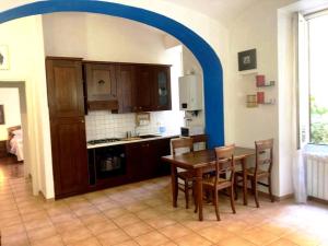 a kitchen with a wooden table and a blue archway at Lovely Apartment in Testaccio, Rome in Rome