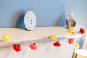 a clock sitting on a shelf with fruit on it at Ferry Nice in Broughty Ferry