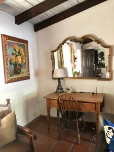 a room with a wooden desk and a mirror at Casa De Vito in Palm Springs