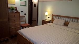 a bedroom with a large bed and a dresser at La Piana Dei Castagni in Castel dʼAiano